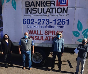 Two Banker Insulation team members standing in front of a company truck.