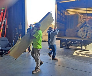 Banker Insulation team members at work, unloading a truck.