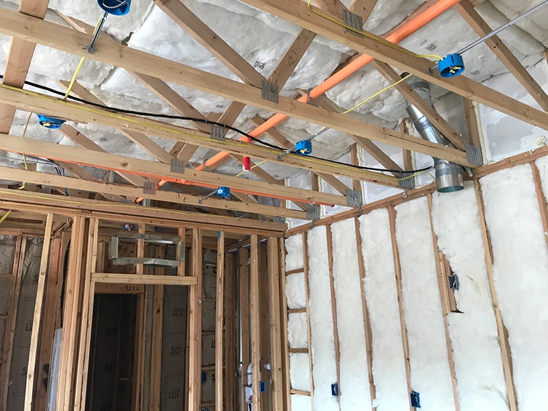 Fiberglass insulation installation on walls and ceiling.