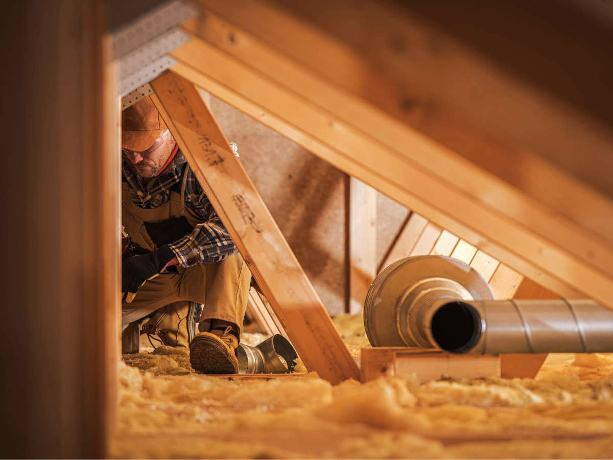 Working installing insulation in attic.