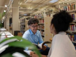 Librarian and library patron having a conversation in a library